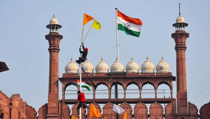 centre serious on farmers flag hoisted on top of red fort